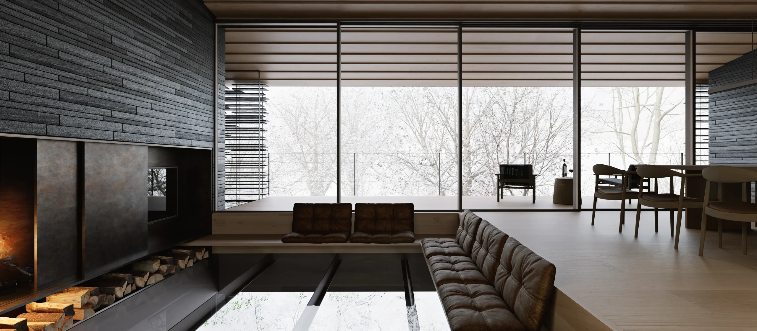 Ukiya living space with natural timber surfaces, dark stone walls, a sunken seating area and full-height forest views.