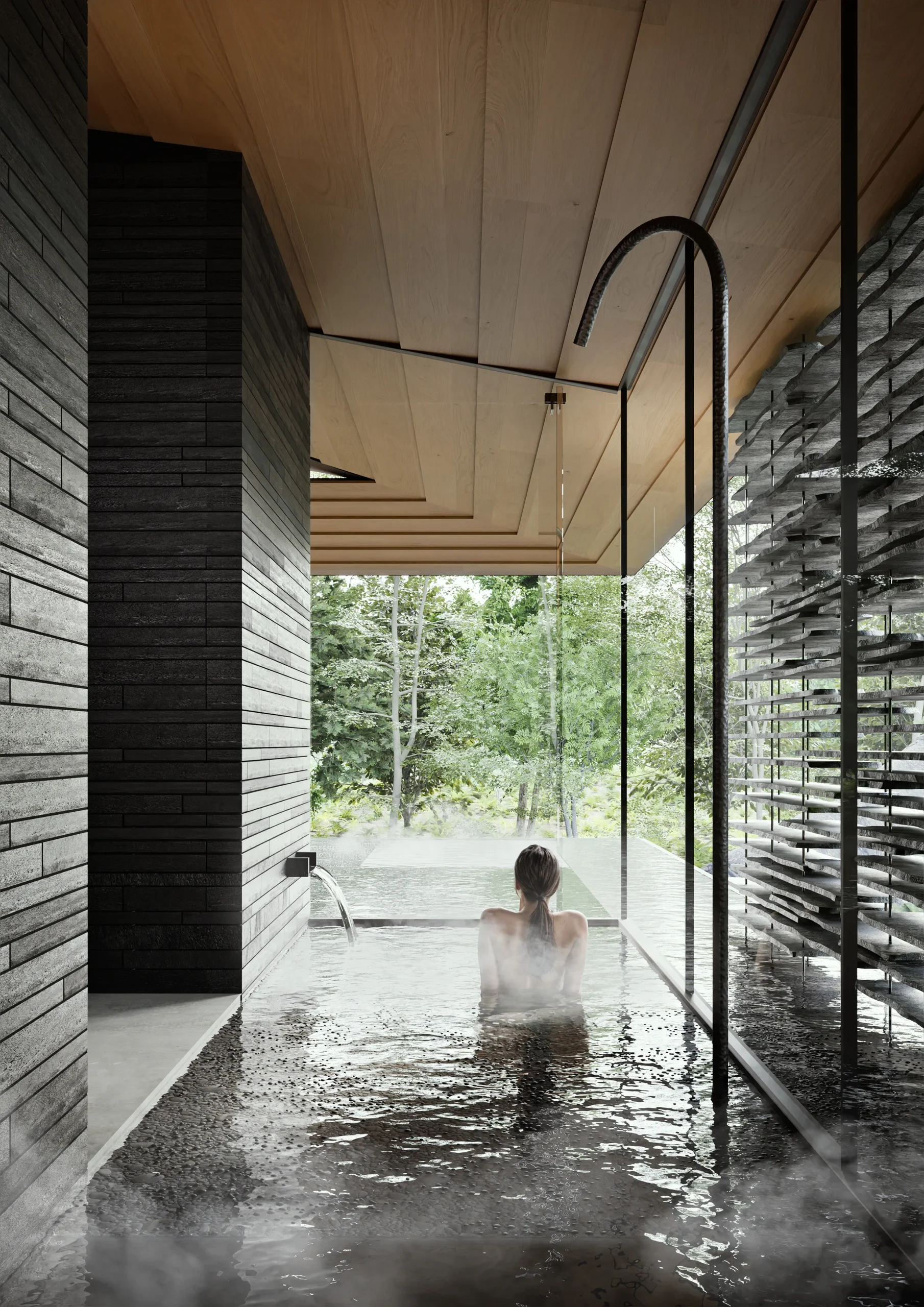Spa bath in Ukiya opening directly towards the forest through full-height glazing, with dark stone and a timber ceiling.